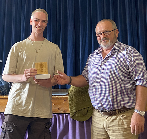 Councillor Clemens presenting an award to a young man